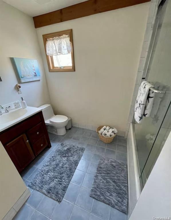 48 Oakhurst Road Hampton Bays, NY 11946 - Photo 21 of 25 a bathroom with a granite countertop sink a toilet and a mirror