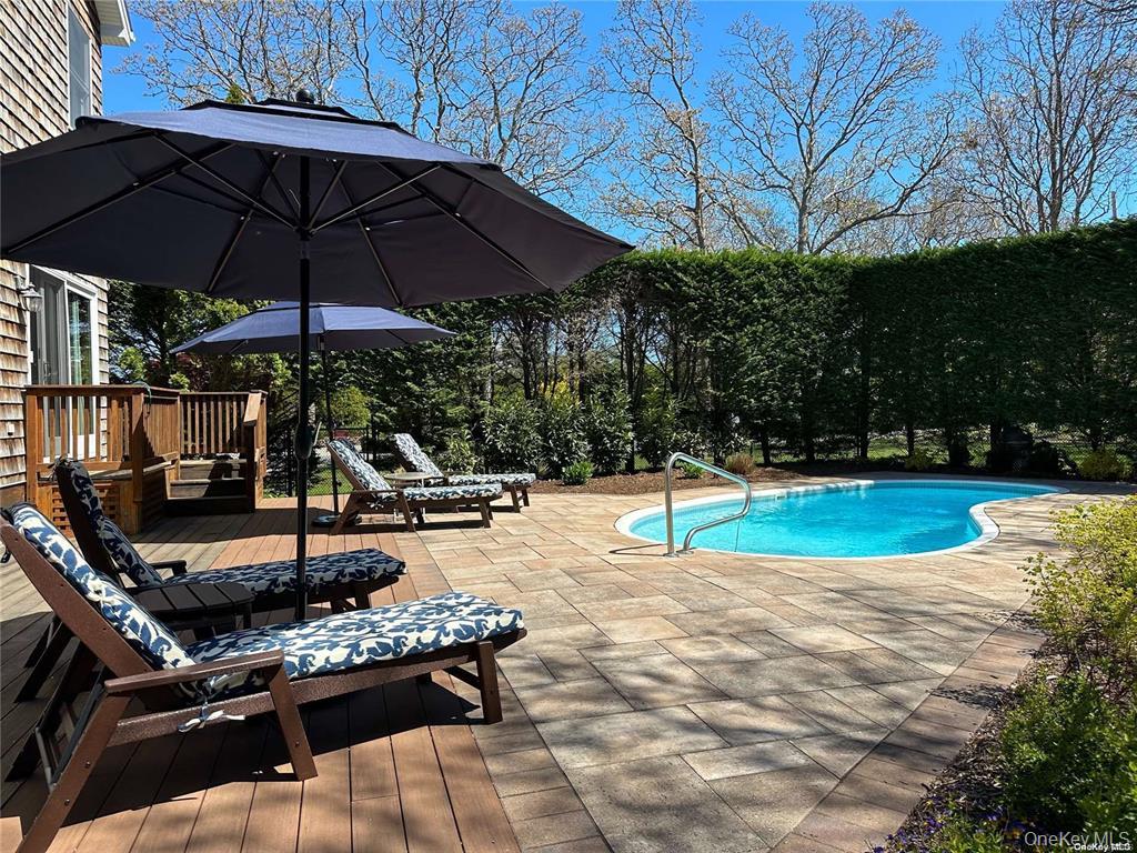 48 Oakhurst Road Hampton Bays, NY 11946 - Photo 4 of 25 a view of a swimming pool with sitting area and furniture
