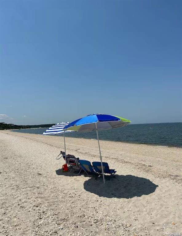 48 Oakhurst Road Hampton Bays, NY 11946 - Photo 5 of 25 a table with chairs and umbrella