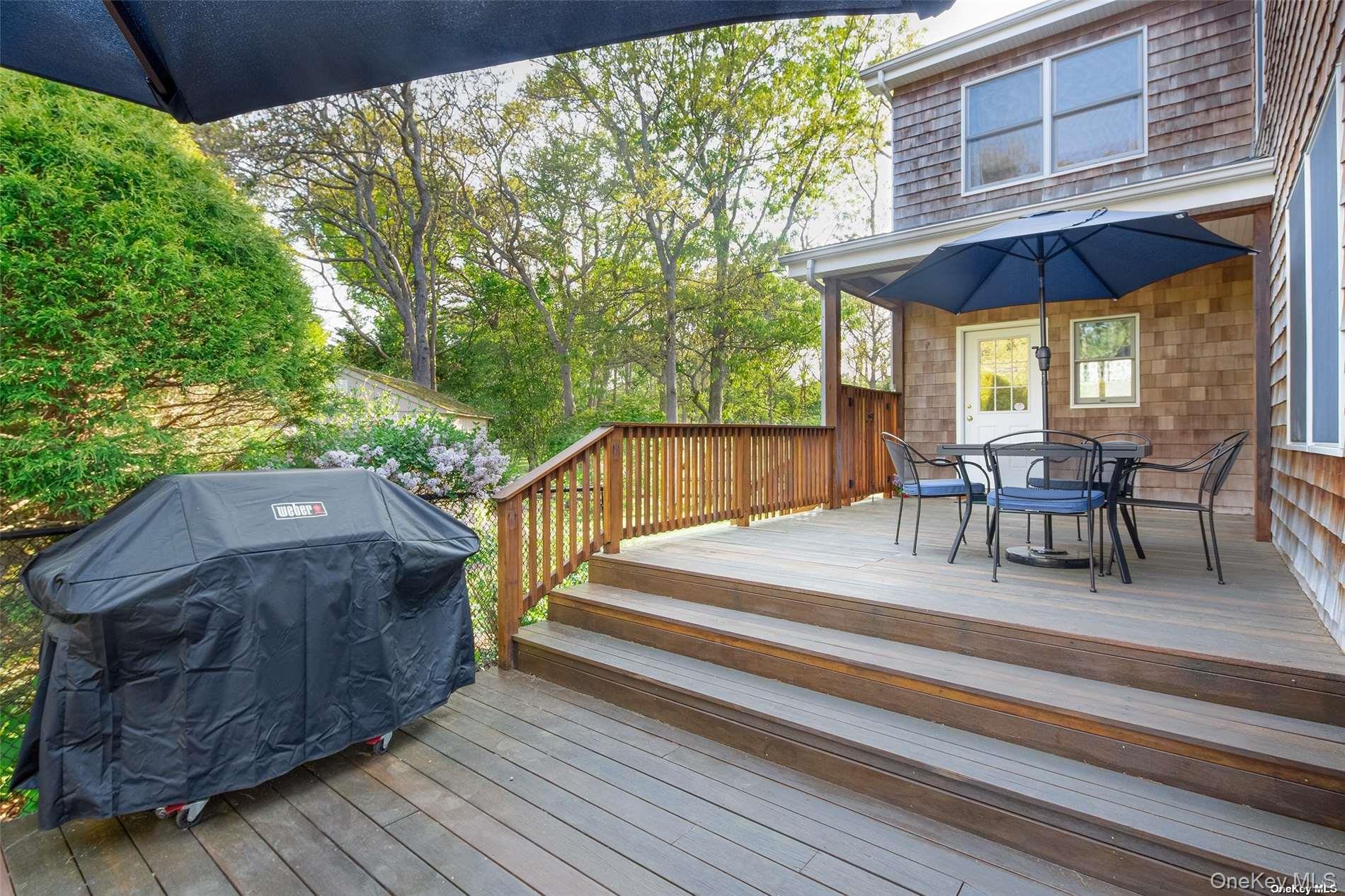 48 Oakhurst Road Hampton Bays, NY 11946 - Photo 6 of 25 a view of backyard with outdoor seating and wooden floor