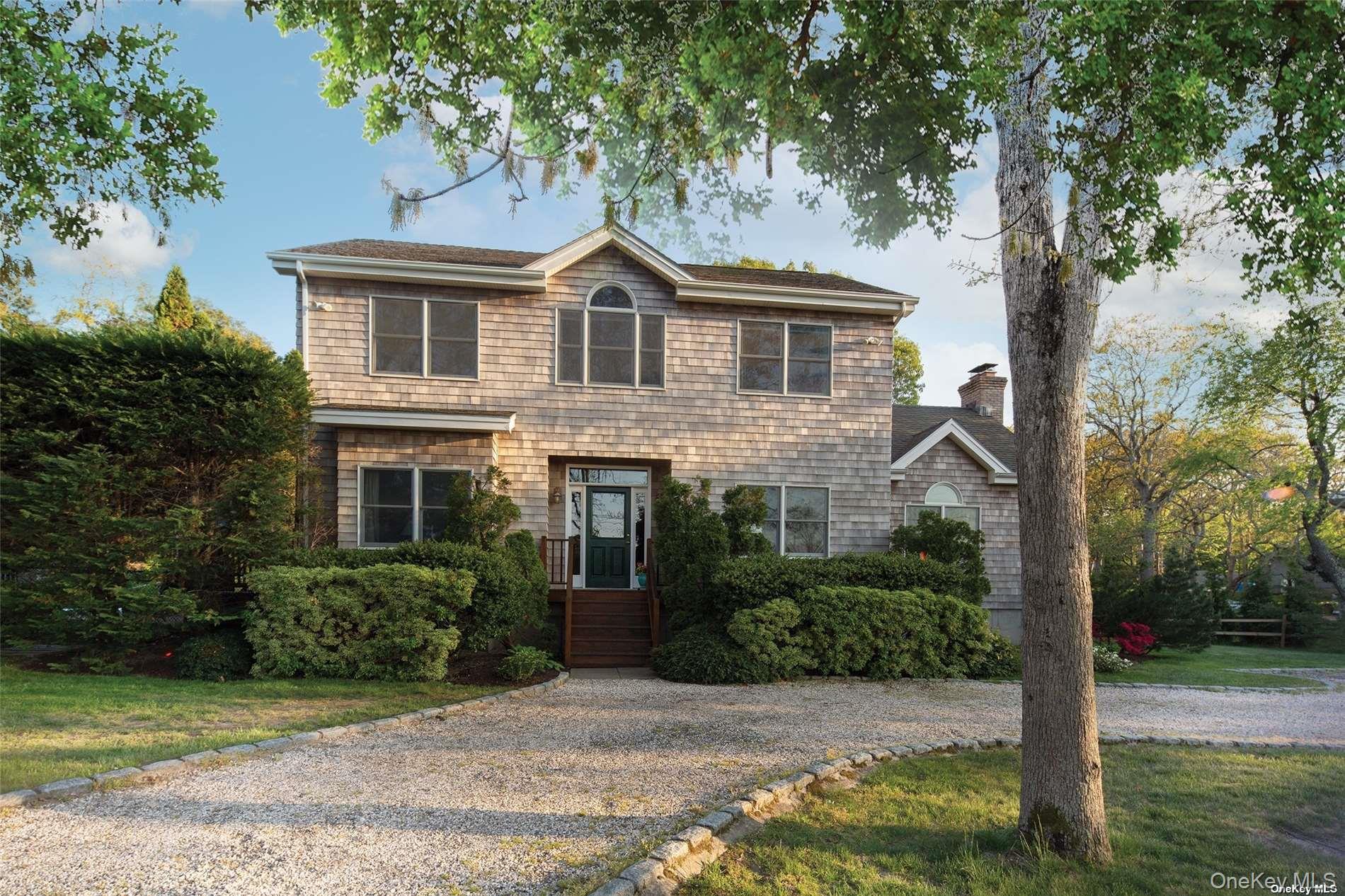 48 Oakhurst Road Hampton Bays, NY 11946 - Photo 7 of 25 a front view of a house with garden