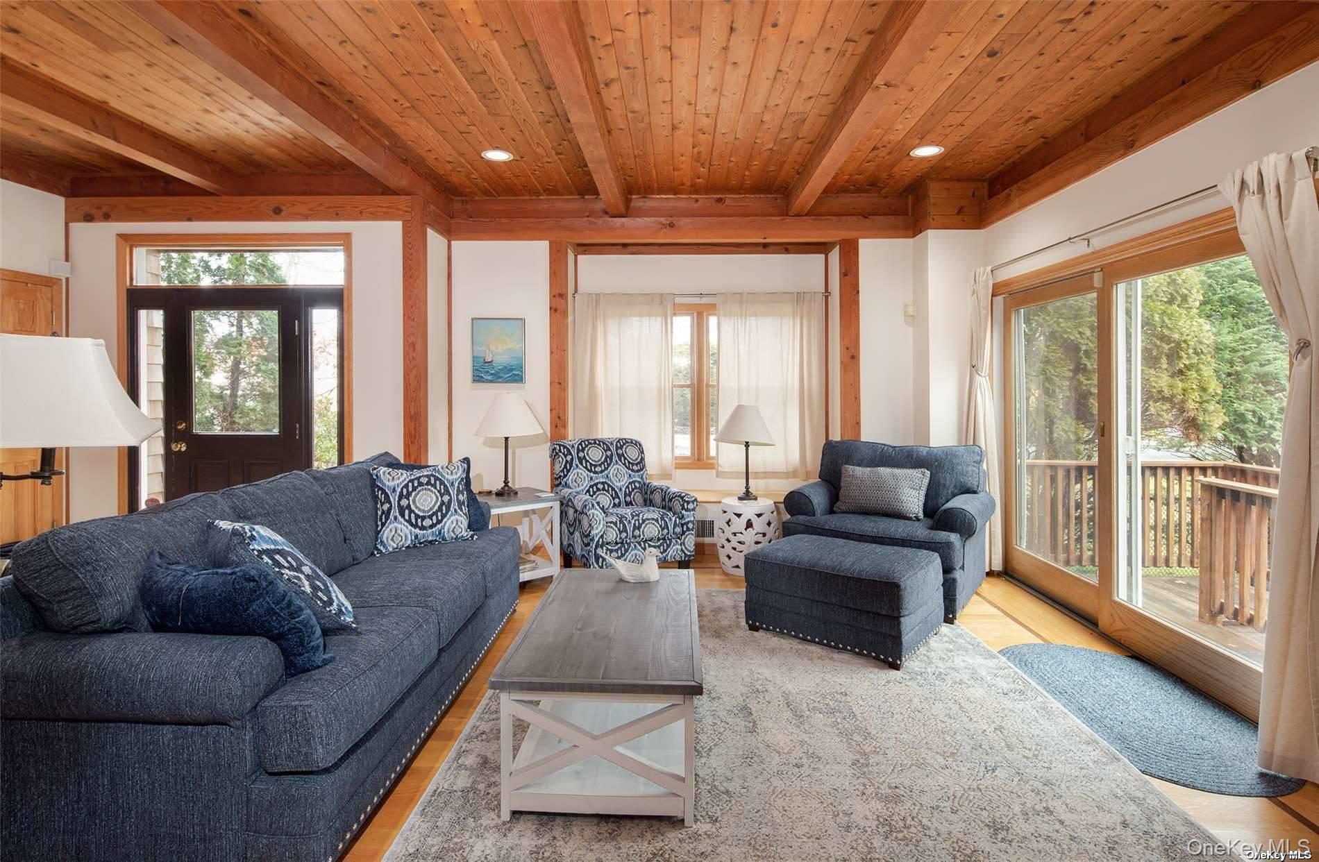 48 Oakhurst Road Hampton Bays, NY 11946 - Photo 8 of 25 a living room with furniture and a large window