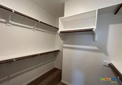 a kitchen with kitchen island granite countertop a sink cabinets and stainless steel appliances