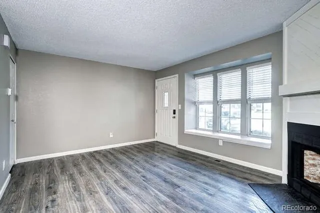 a kitchen with stainless steel appliances granite countertop a refrigerator a sink and white cabinets
