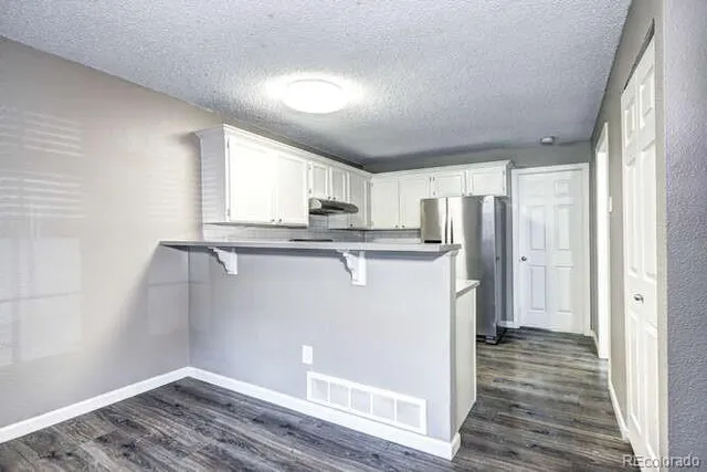 a kitchen with a sink stove and refrigerator