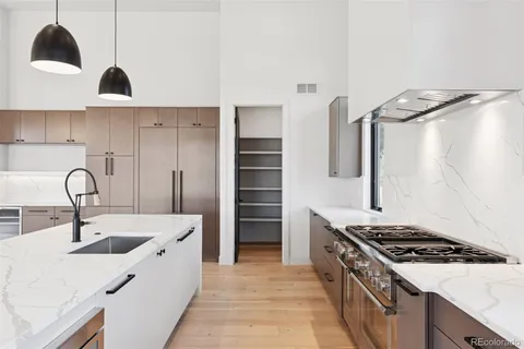 a kitchen with a sink and large window