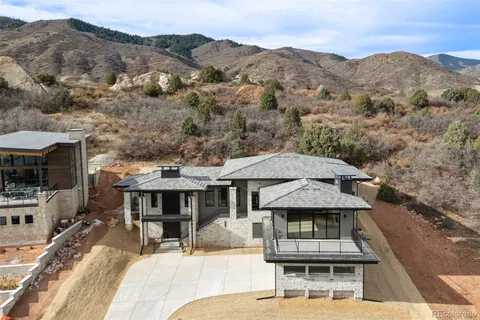 a view of a patio with a table and chairs and floor to ceiling window