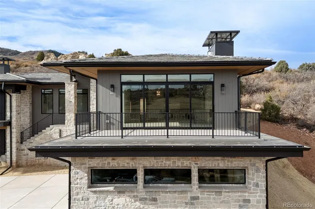 a kitchen with stainless steel appliances kitchen island granite countertop a sink a stove and refrigerator