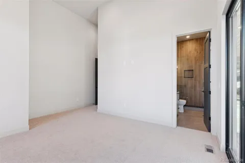 a view of hallway with cabinets and wooden floor