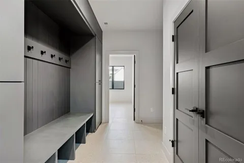 an empty room with wooden floor windows and a ceiling fan