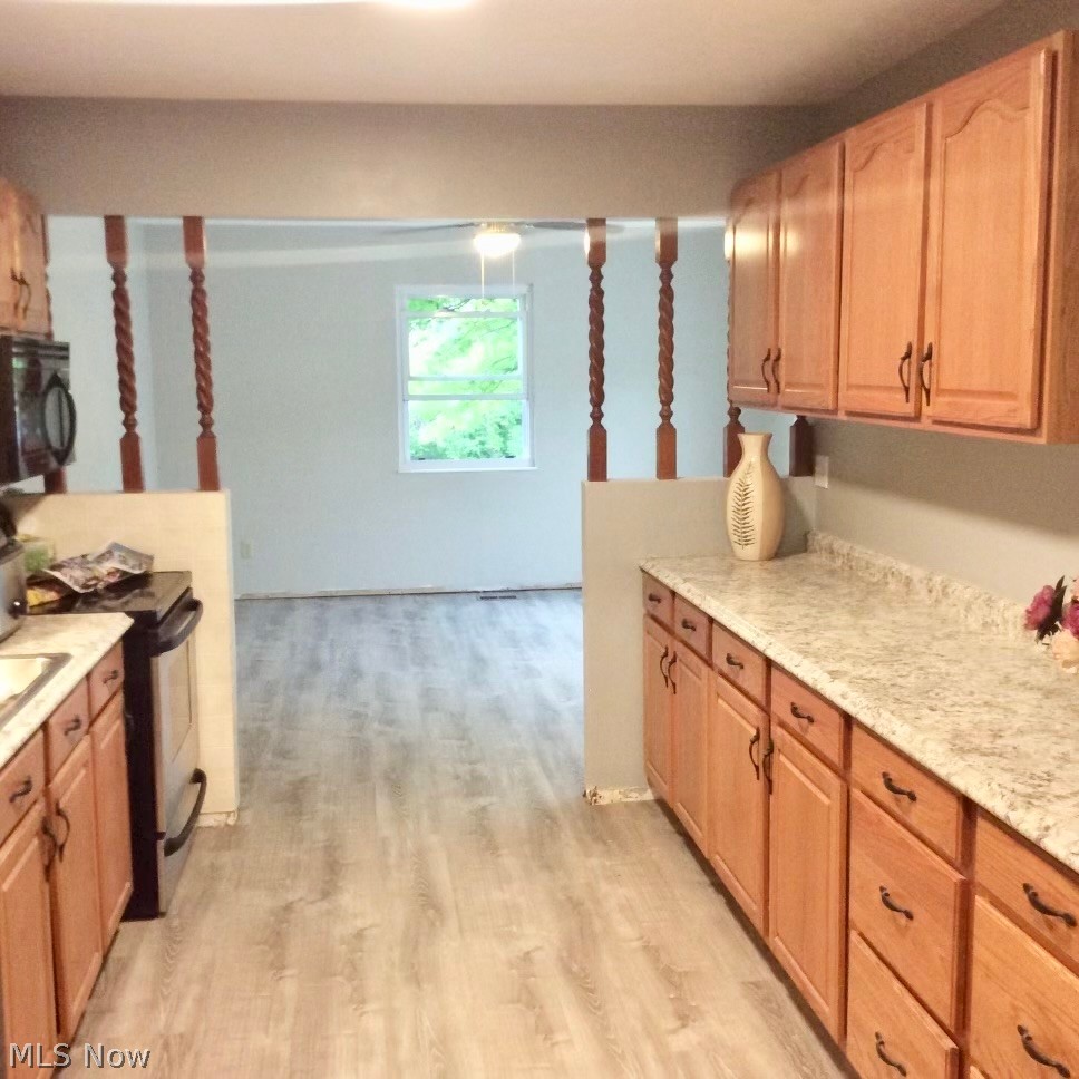 10071 Hazelton Road Streetsboro, OH 44241 - Photo 10 of 16 Kitchen featuring electric stove, light hardwood / wood-style floors, and light stone counters