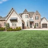 a view of house that has a yard