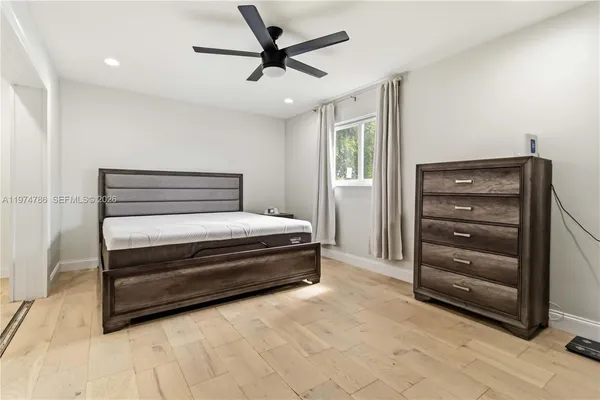 a bed room with a bed and a ceiling fan