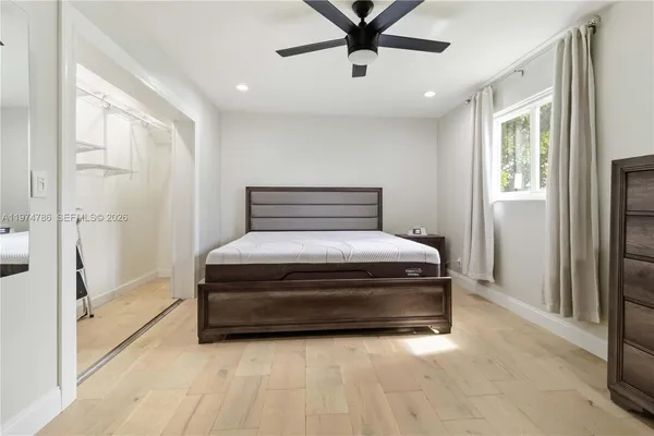 a bedroom with a bed and a window