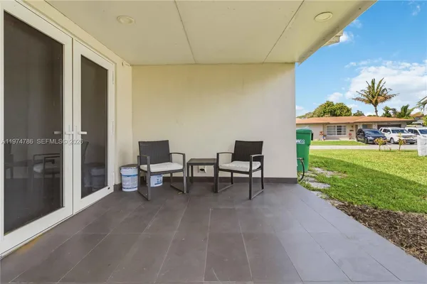 a view of a patio with dining table and chairs