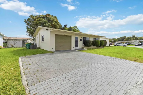 a view of a house with a yard and garage
