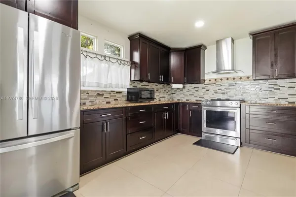 a kitchen with stainless steel appliances a stove a sink and a refrigerator