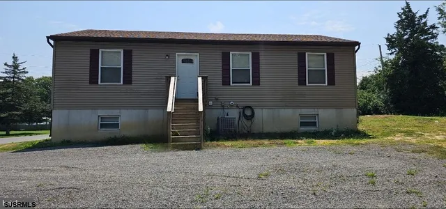 a view of backyard of house and trees
