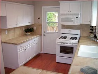 a kitchen with cabinets appliances and a window