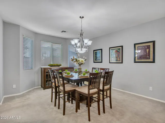 a kitchen with kitchen island granite countertop a stove sink microwave and cabinets