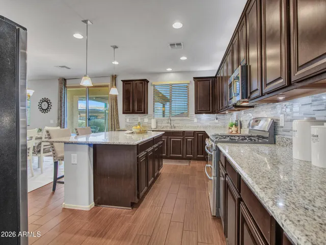 a view of a dining room with furniture a chandelier and wooden floor