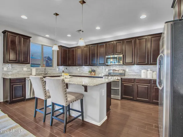 a view of a dining room with furniture wooden floor and a chandelier