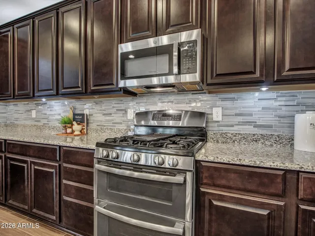 a front view of a house with swimming pool having outdoor seating