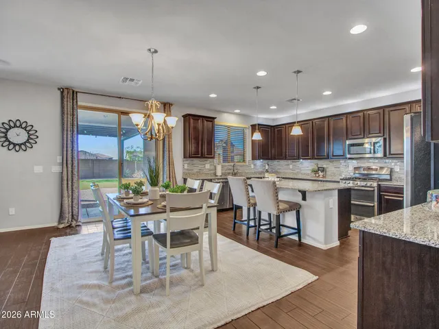 a living room with couches bookshelf and a flat screen tv