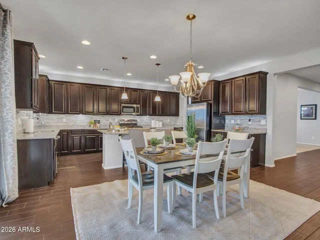 a living room with furniture a lamp and a large window