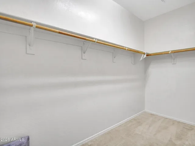 a spacious bedroom with a bed and a chandelier