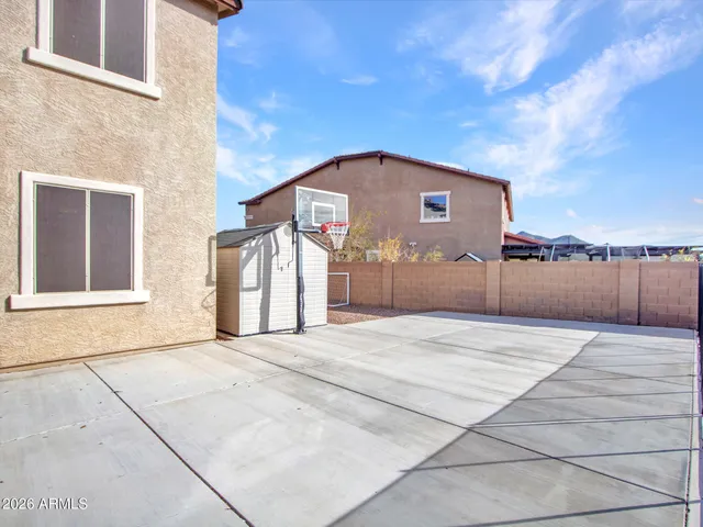 an aerial view of a house with a yard patio and garage