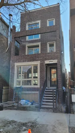 a kitchen with stainless steel appliances a sink cabinets and wooden floor