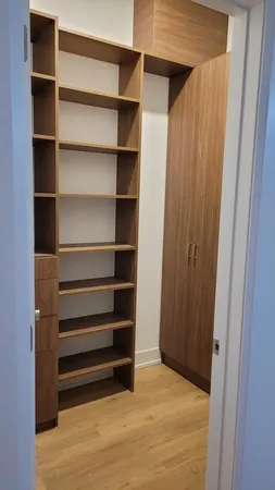 a view of walk in closet with empty racks