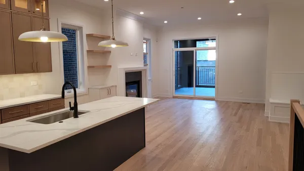 a kitchen with stainless steel appliances granite countertop a refrigerator a sink and a stove