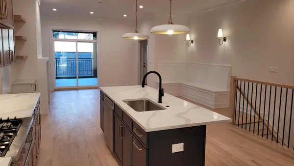a kitchen with a sink and a mirror