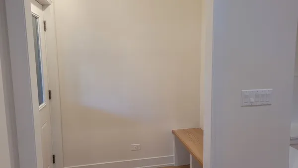 a view of walk in closet with empty racks
