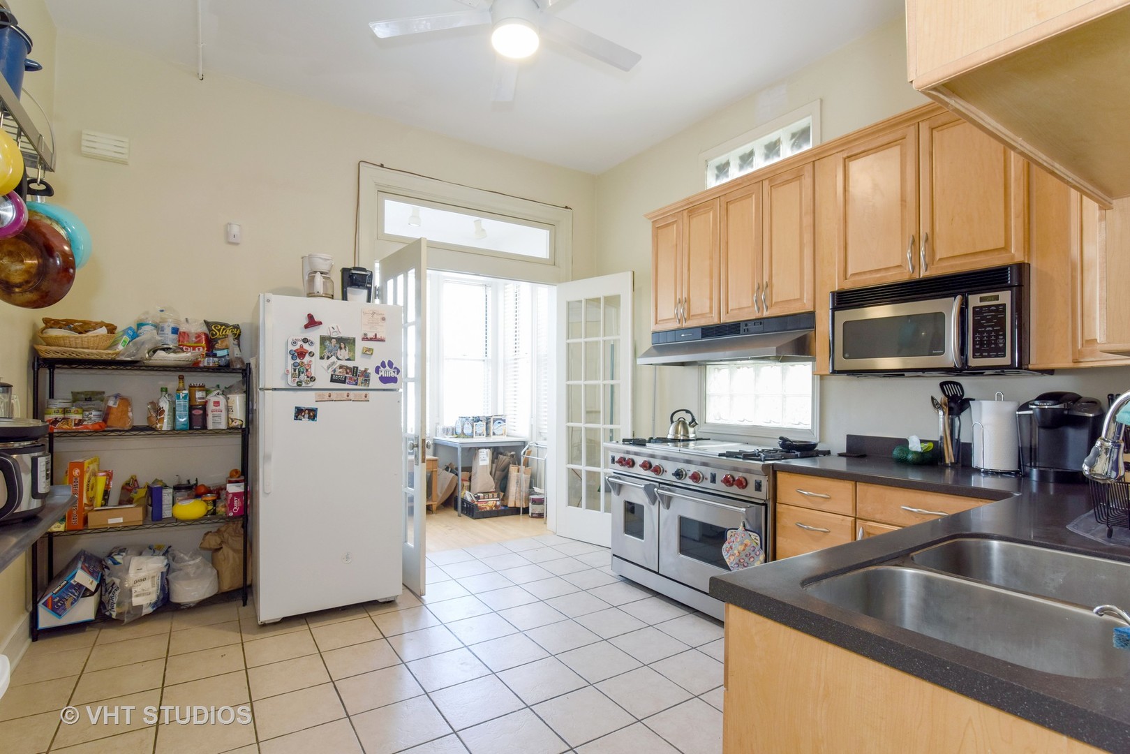 1424 West Fletcher Street Chicago, IL 60657 - Photo 4 of 24 a kitchen with granite countertop a refrigerator and a sink