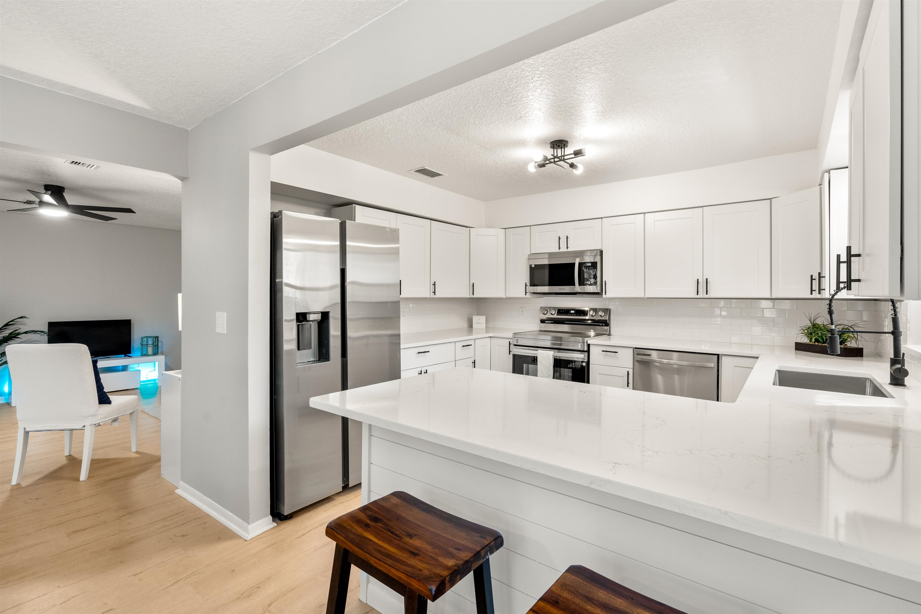 176 Linden Road St. Augustine, FL 32086 - Photo 12 of 50 a kitchen with stainless steel appliances a refrigerator sink and white cabinets