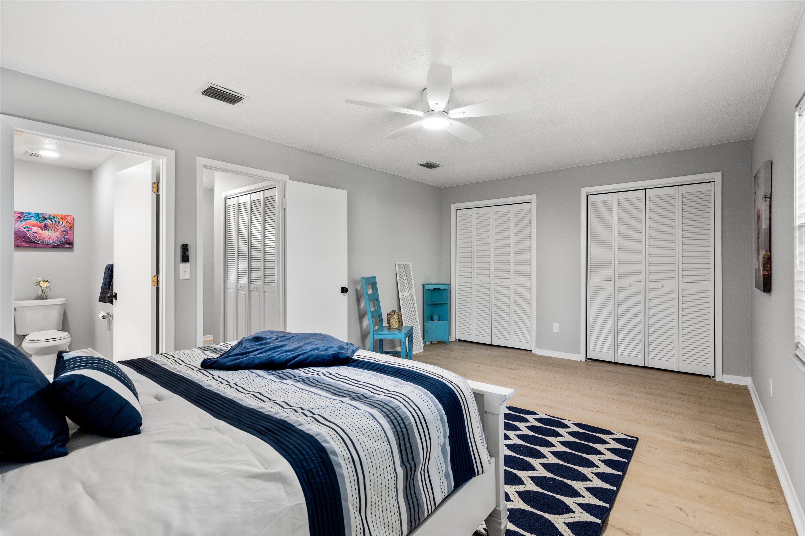 176 Linden Road St. Augustine, FL 32086 - Photo 25 of 50 a bedroom with a bed and a chandelier