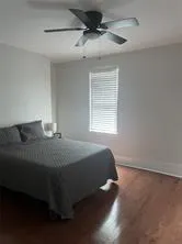 a view of empty room with window and ceiling fan