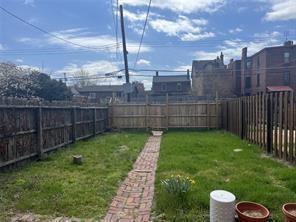 1327 Liverpool Street, Unit 1 Pittsburgh, PA 15233 - Photo 24 of 24 a view of a backyard with a barbeque and wooden fence
