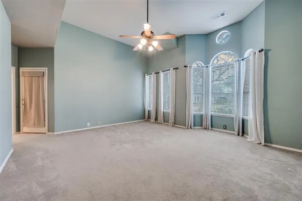 a view of a livingroom with a chandelier fan