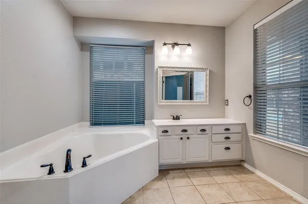 a bathroom with a bathtub and a window