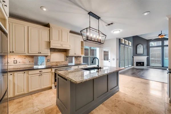 a kitchen with stainless steel appliances granite countertop a sink a stove and a granite counter tops