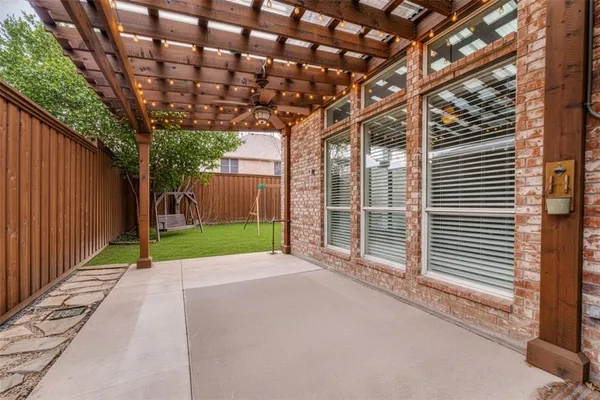 a view of a backyard with wooden fence