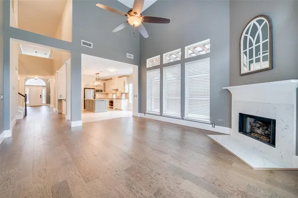 a view of an empty room with a fireplace and a window
