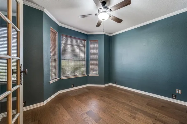 a view of a livingroom with a ceiling fan and window