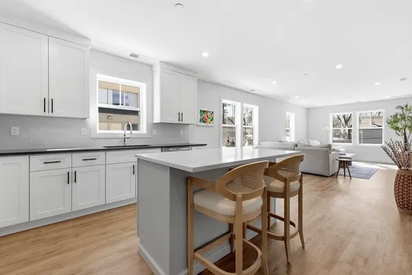 a kitchen with a table chairs sink and cabinets