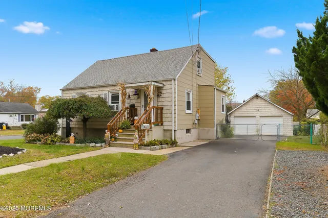 a view of a house with a yard and potted plants
