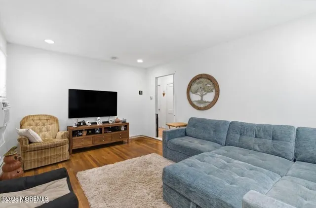 a living room with furniture a couch and a flat screen tv
